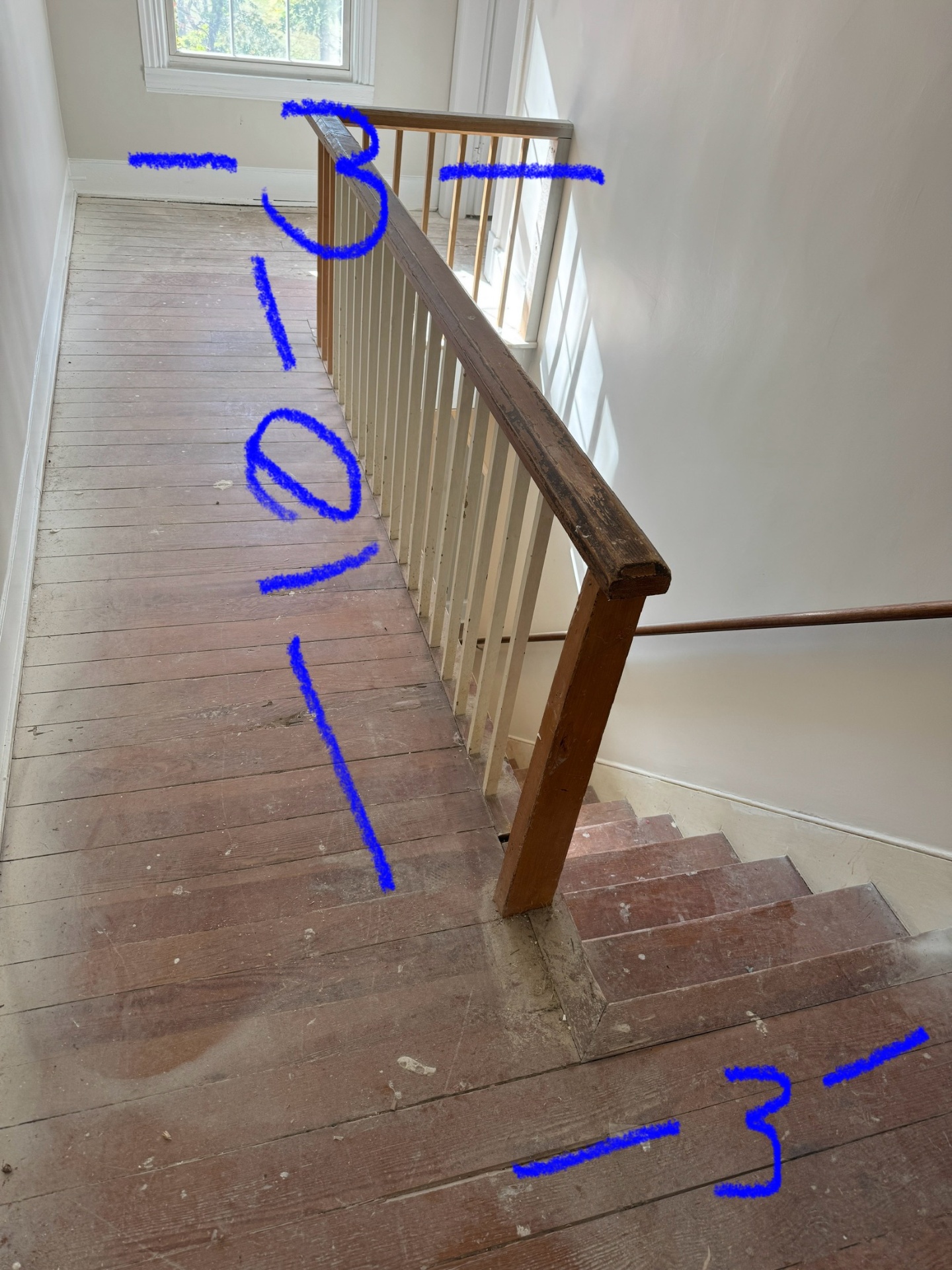 Worn hardwood floor before dustless sanding
